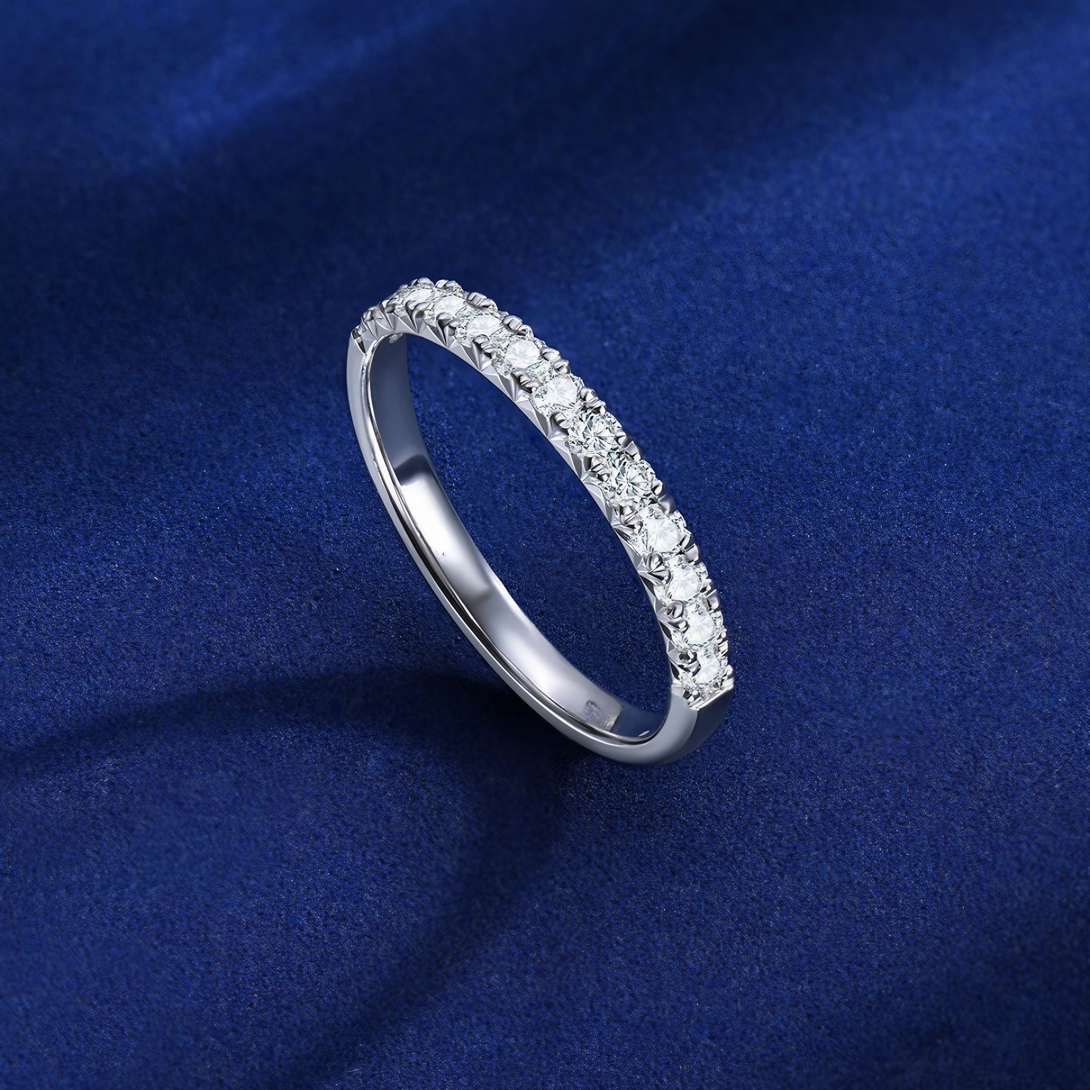 Detailed composition of diamond rings under soft lighting and rich blue gradient.