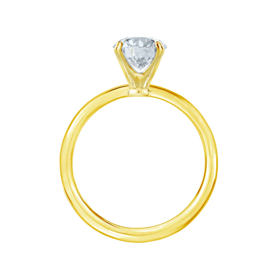 Side profile of LILY 18k yellow gold petite channel set engagement ring, round cut lab diamond solitaire with delicate band