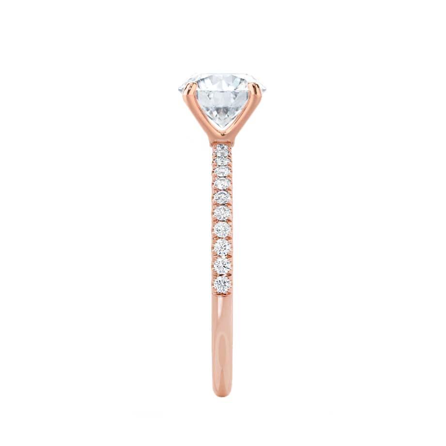 Side profile of solitaire emerald cut lab diamond ring in rose gold pavé band