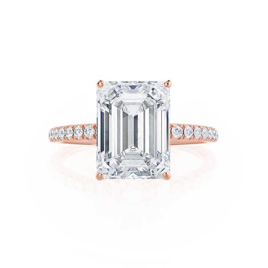 Straight front view of emerald cut lab diamond solitaire ring with rose gold pavé band