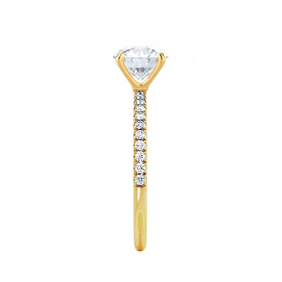 Side profile of solitaire emerald cut lab diamond ring with yellow gold pavé band