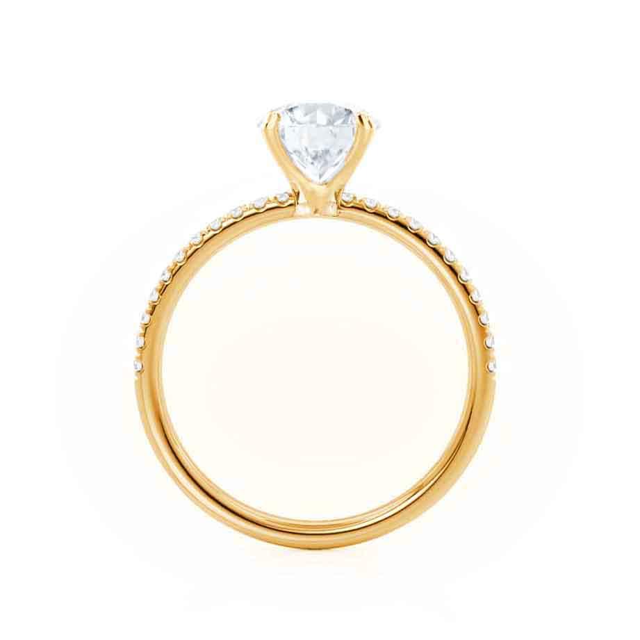 Top view of emerald cut lab diamond engagement ring in yellow gold pavé band