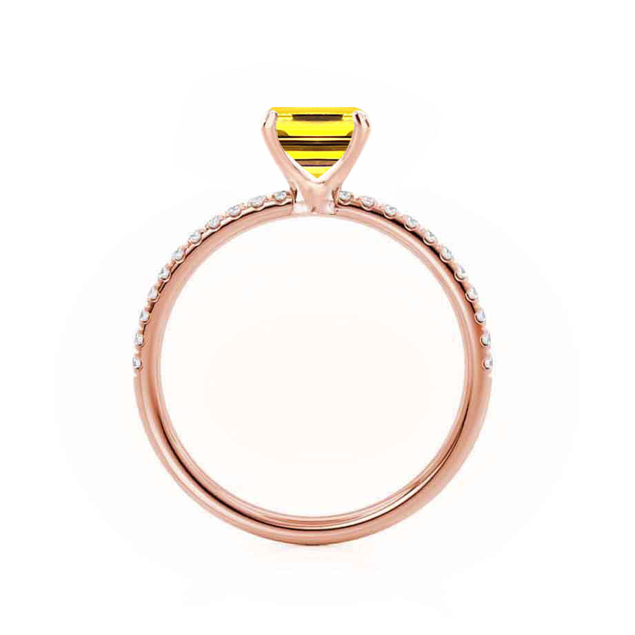 Top view capturing the clean emerald facets and delicate micro pavé detailing on both sides.