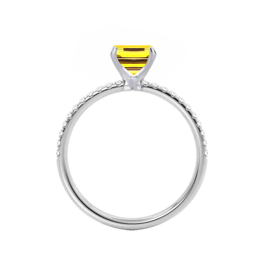 Top view revealing the symmetrical micro pavé diamond band and clean emerald facets of the center stone.