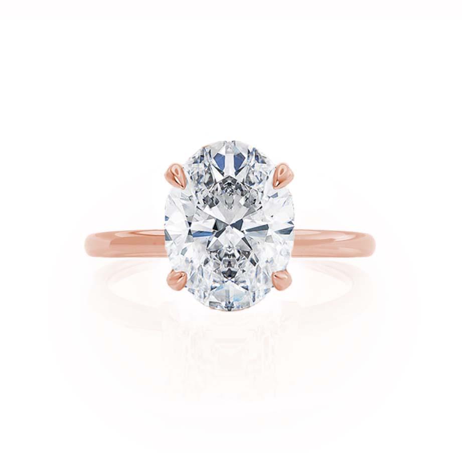 Angled view of the Camellia ring, displaying the oval-cut diamond and elegant 4-claw mount.