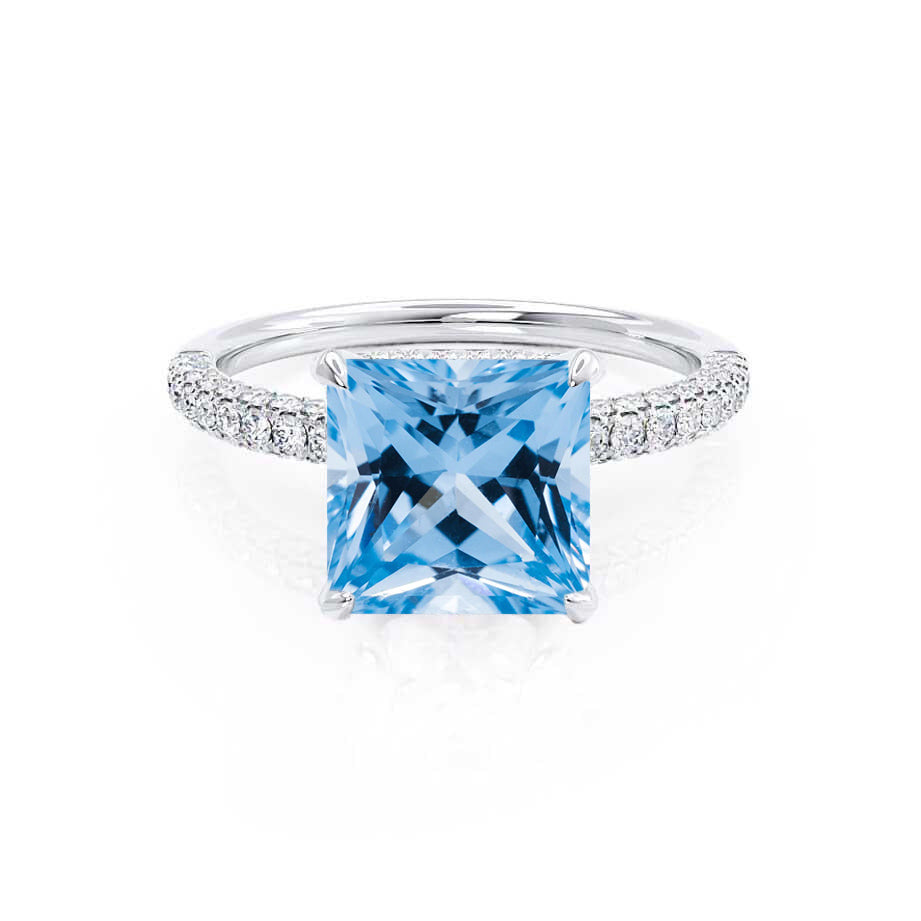 Front view of the Freesia Ring in platinum, showcasing the vivid blue princess-cut spinel and triple pavé diamond band.