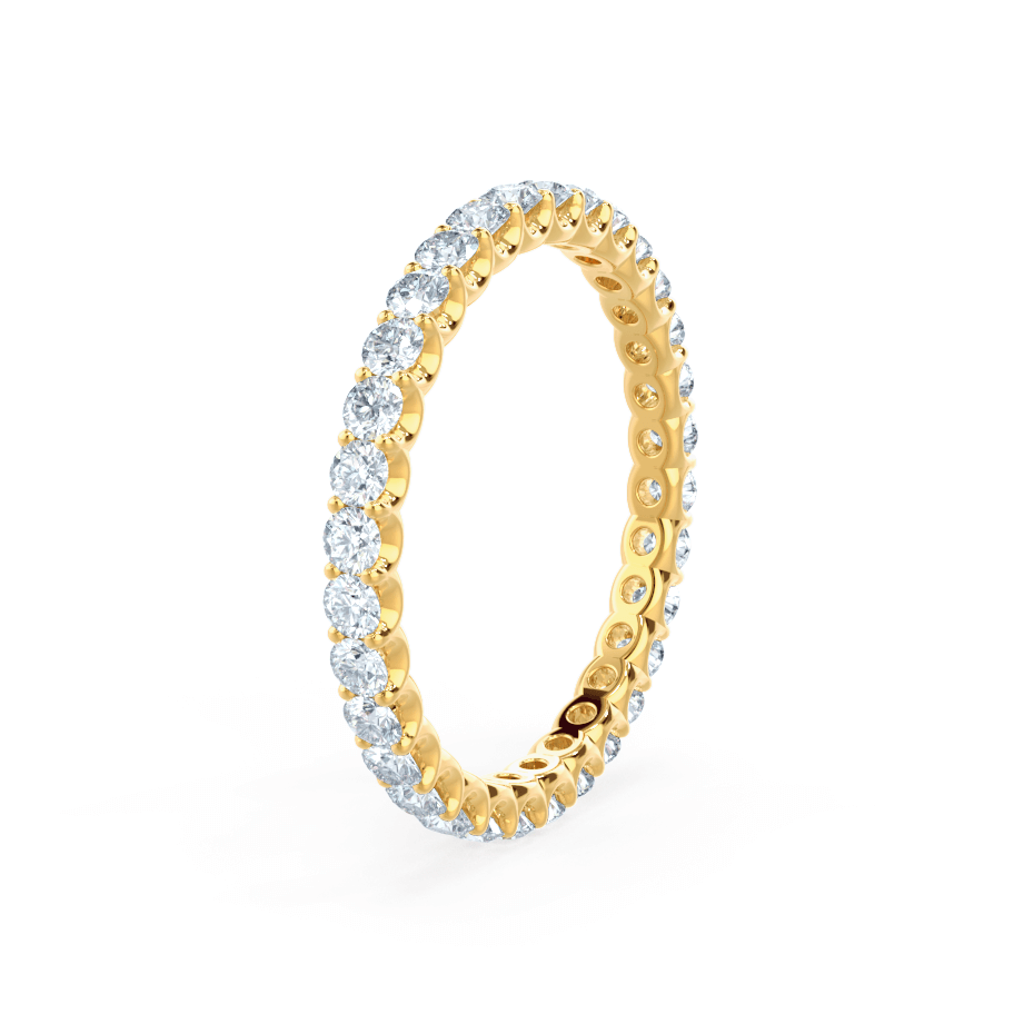 Eternity band featuring illusion-set oval diamonds in yellow gold, full circle brilliance.