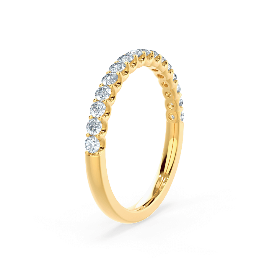 Vertical view of a simple yellow gold band with partial pavé diamonds and a polished lower half.