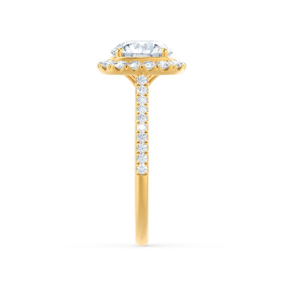 Top view of elongated cushion cut lab diamond halo engagement ring in 18k yellow gold