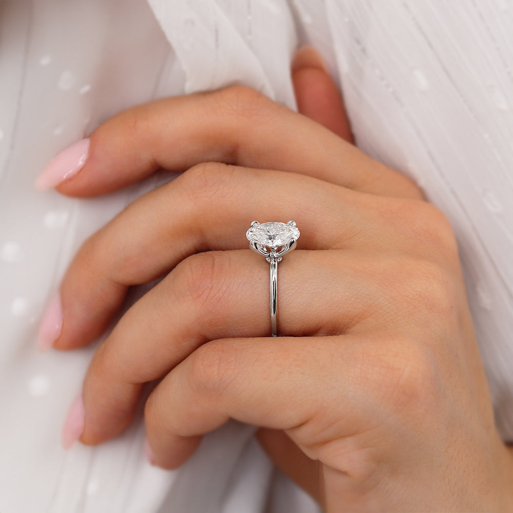 Elegant lifestyle shot of oval cut lab diamond ring in white gold on model's hand
