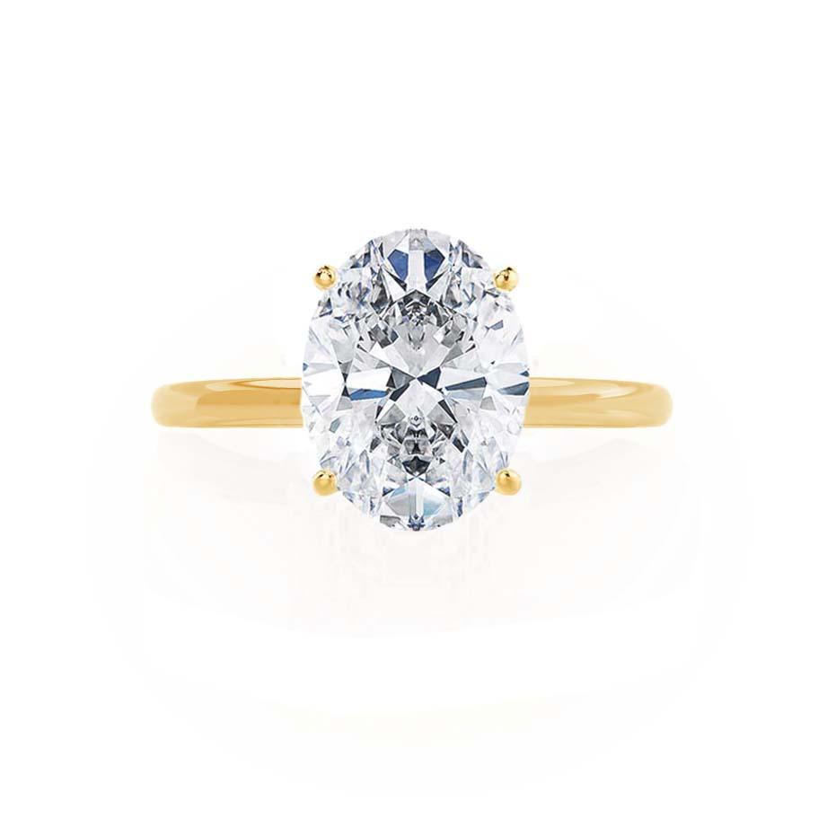Angled view of lab grown oval diamond ring with yellow gold mount