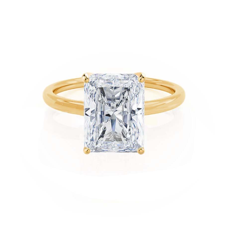 Front view of the radiant cut diamond set in vibrant yellow gold, highlighting brilliance and contrast.