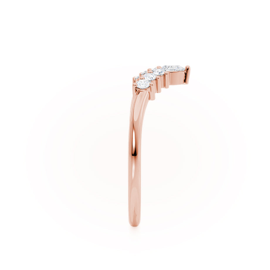 Side view of curved rose gold band with angled diamond setting.