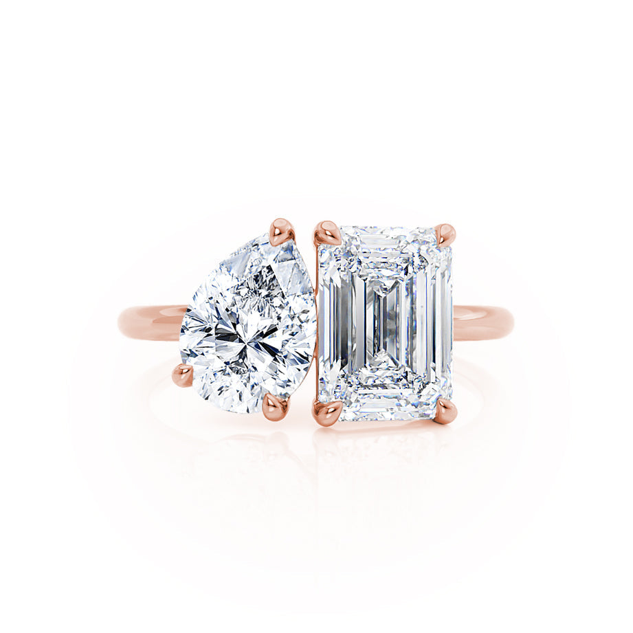 Angled view of Toi Et Moi engagement ring with emerald and pear lab diamonds in 18k rose gold