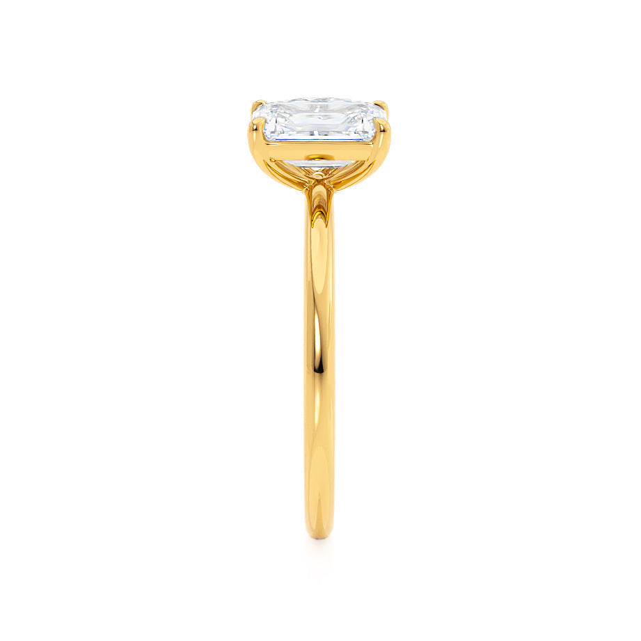 Top view of emerald and pear cut Toi Et Moi engagement ring in 18k yellow gold