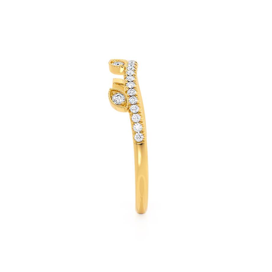 Side profile of the curved yellow gold ring with a row of brilliant white diamonds.