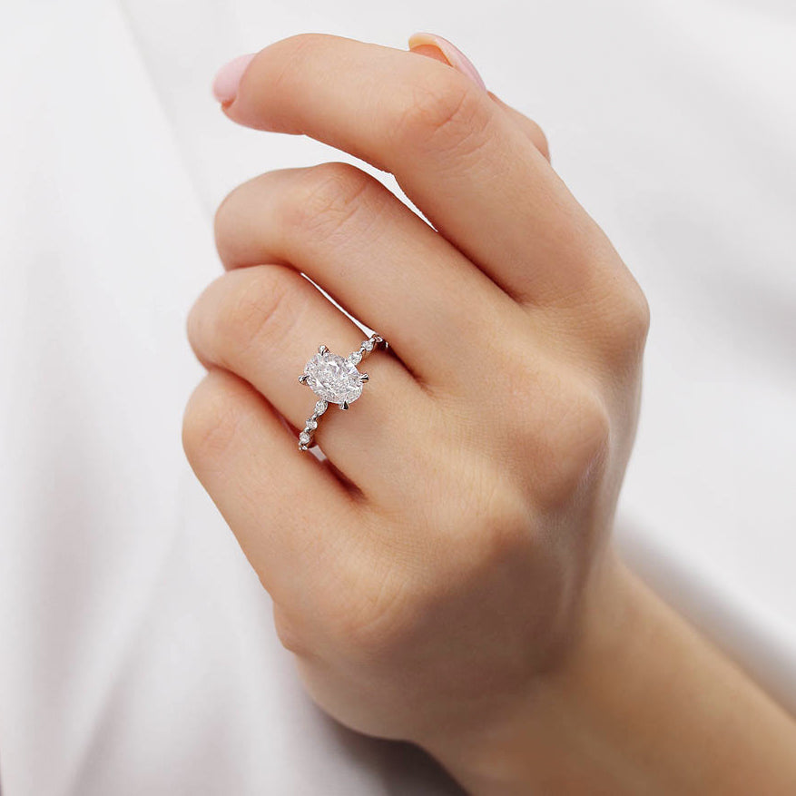 Woman wearing ASTER oval cut lab diamond engagement ring in 18k white gold, elegant hand view