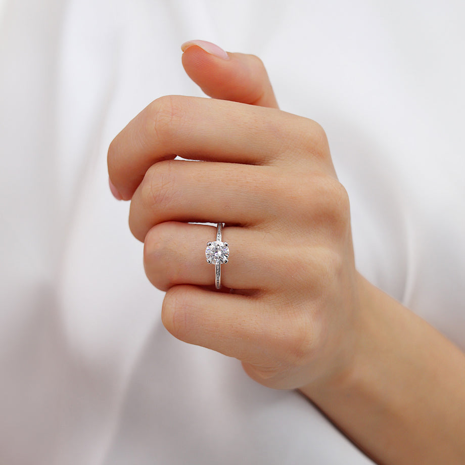 Model wearing LILY platinum 950 channel set engagement ring with round cut lab diamond centre stone