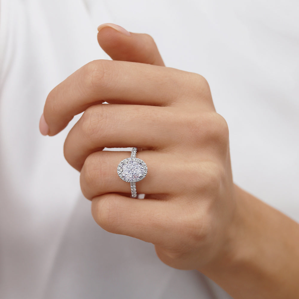 Model wearing PEONY oval cut lab diamond 18k white gold halo engagement ring, elegant close-up on hand