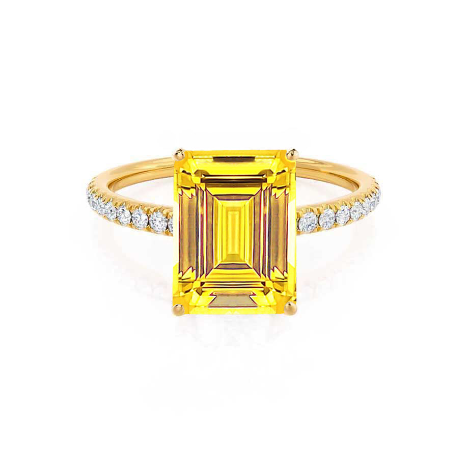 Front view showcasing the vivid emerald-cut yellow sapphire, flanked by brilliant pavé diamonds on a rich 18K yellow gold band.