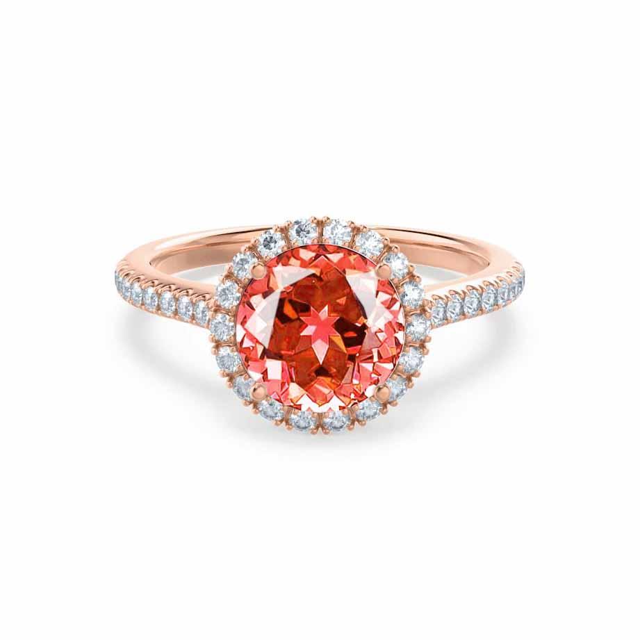 Front view featuring the Padparadscha sapphire cradled in a delicate halo of diamonds, set in romantic 18k rose gold.