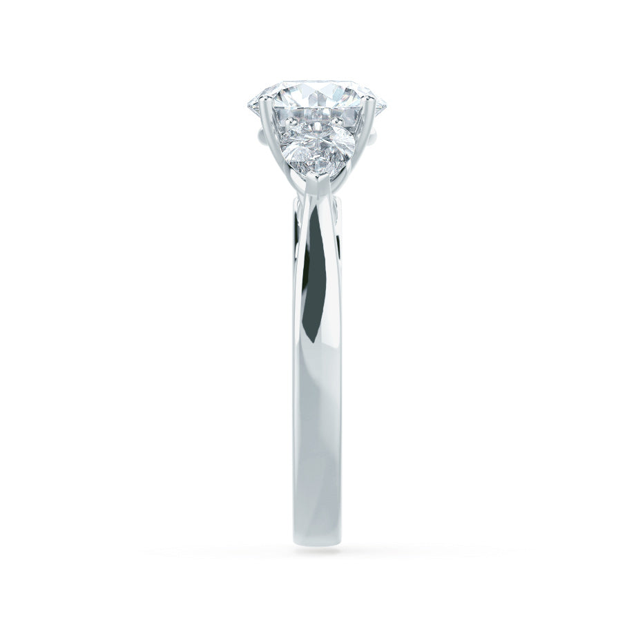 Profile view of oval cut lab diamond with pear side diamonds trilogy engagement ring in 18k white gold
