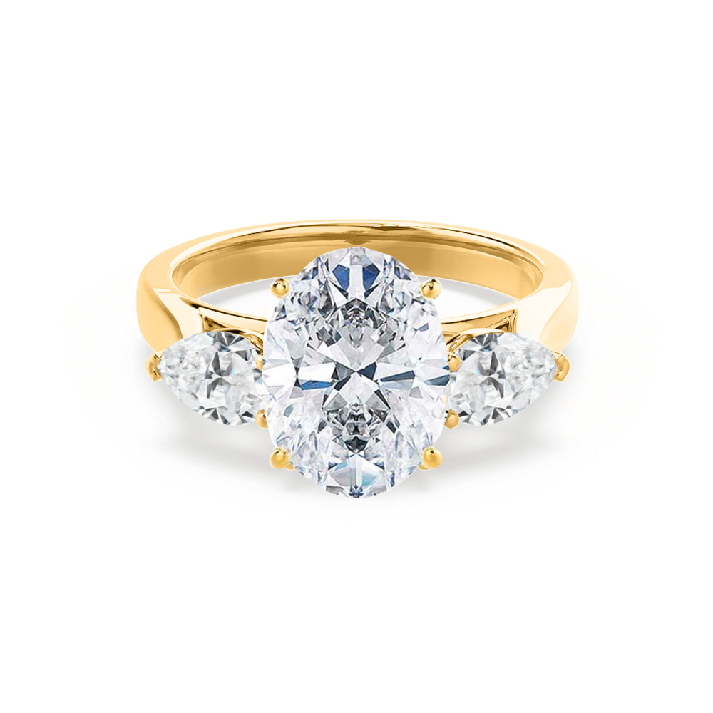 Oval lab diamond trilogy engagement ring in 18k yellow gold with pear-shaped side stones, front view