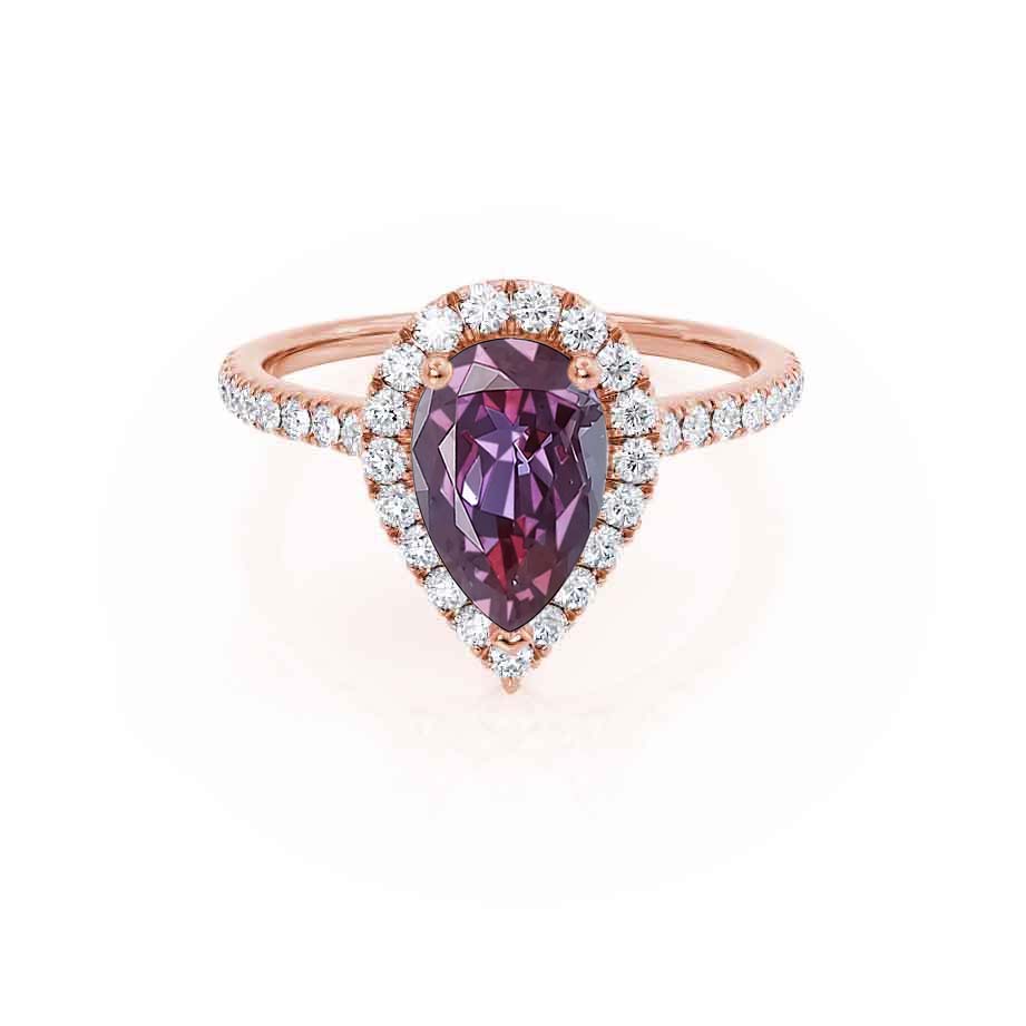 Front view – The lab-grown Alexandrite radiates violet brilliance at the center of this warm 18k rose gold halo design.