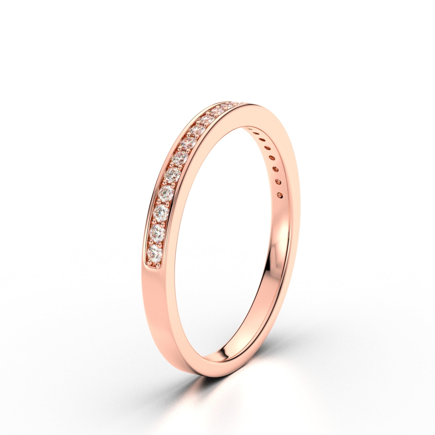 Knife-edge rose gold diamond band with delicate pavé line, angled view.