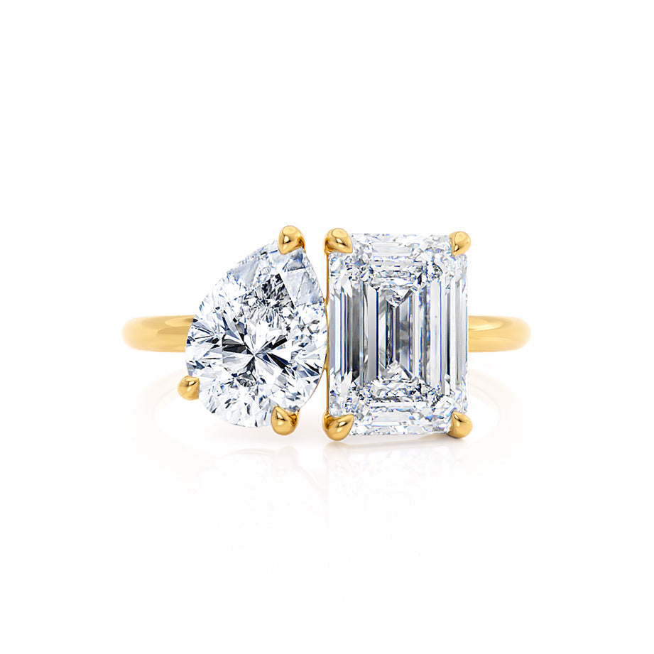Side profile of Toi Et Moi engagement ring with emerald and pear lab diamonds in 18k yellow gold
