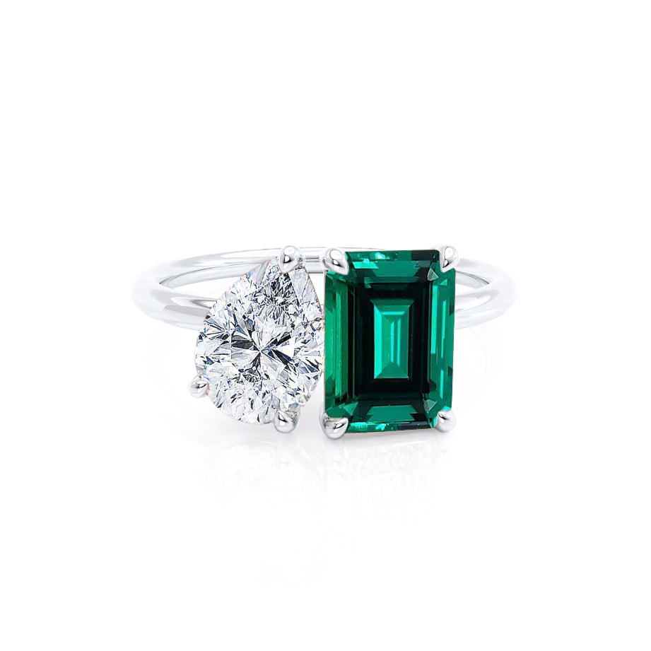 Front view – Captures the elegant asymmetry of the Toi et Moi design: pear-cut lab diamond paired with a vivid emerald-cut green emerald.