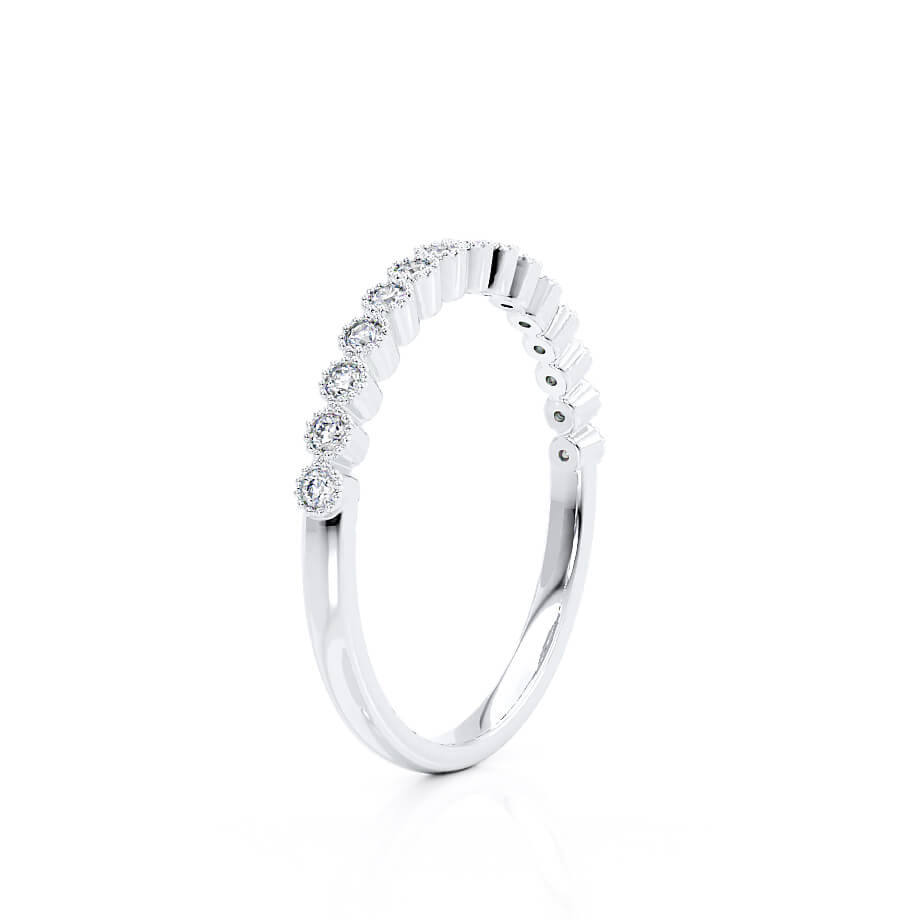 Slanted angle of a half-eternity white gold ring, brilliant-cut diamonds in classic shared prongs.