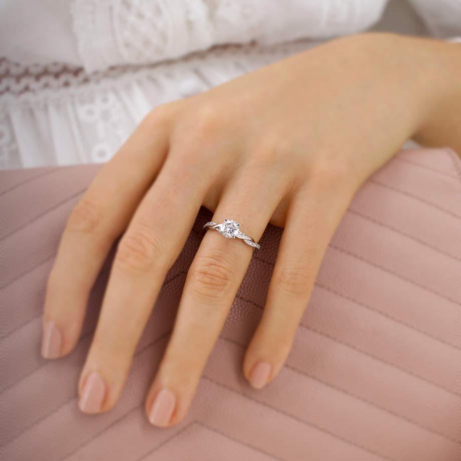 Model showcasing the Wisteria lab diamond solitaire ring in white gold with delicate pavé accents