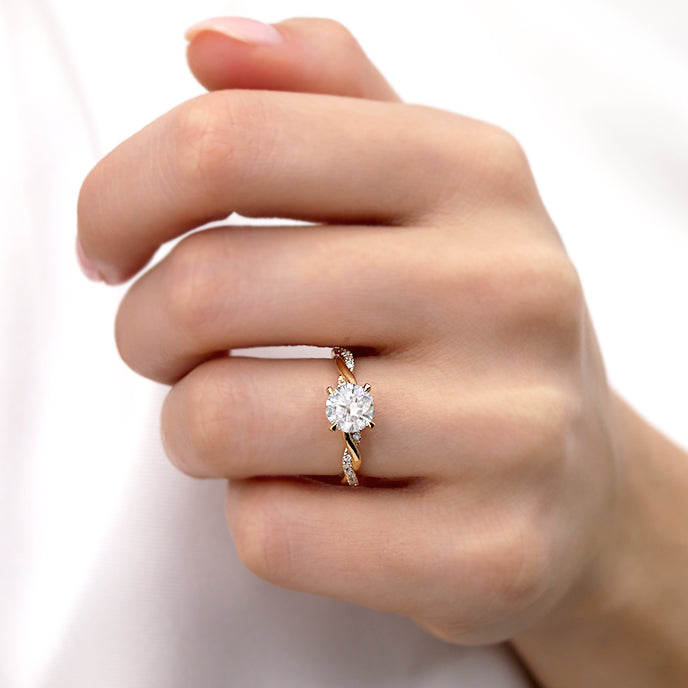 Model wearing the Wisteria round lab diamond ring on both hands, showing elegant yellow gold setting