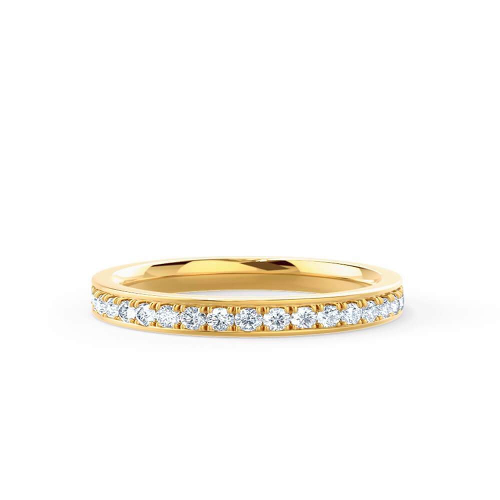 Slim yellow gold micro pave ring shown on hand, ideal for stacking or minimalist wear.